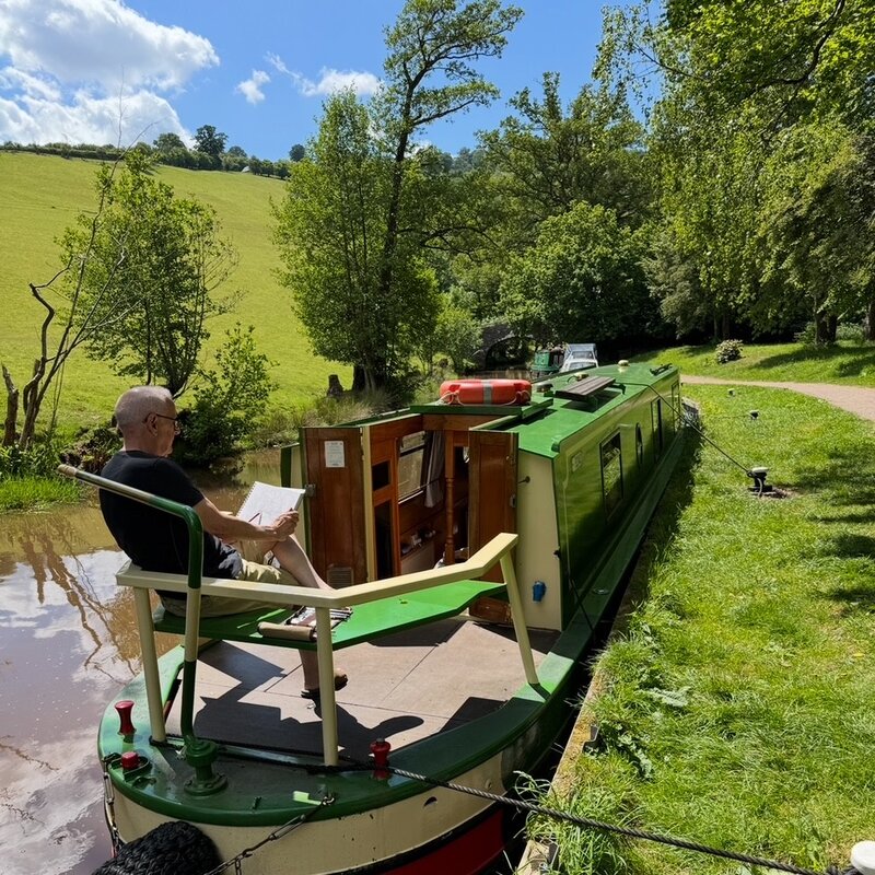 Mike Mills sketching on a narrowboat