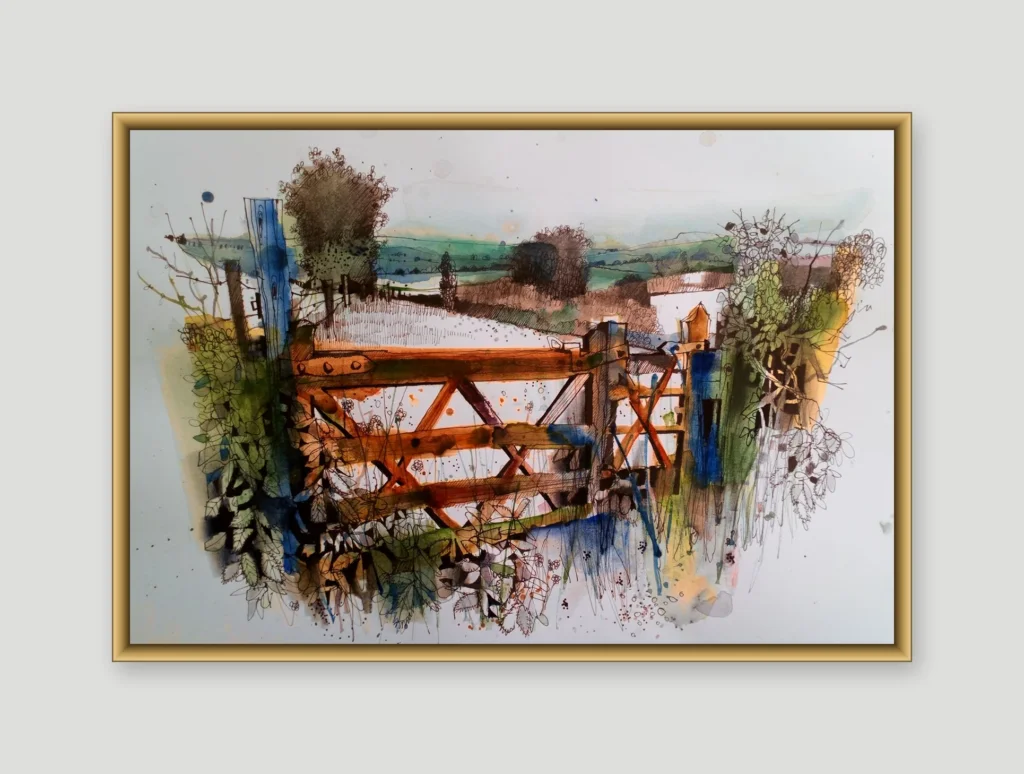 Watercolour and ink painting of a wooden farm gate with a blue-painted post, surrounded by wildflowers and hedgerow, with rolling green hills and a farmhouse in the background, shown in a gold frame