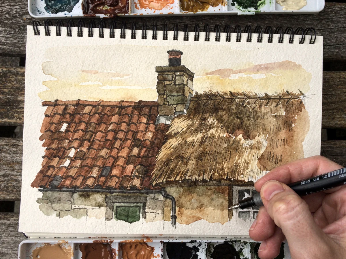 Watercolour and ink sketch of a cottage roofline with terracotta tiles, a chimney, and a section of thatch