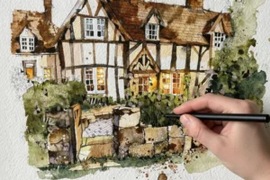 Tudor manor house with detailed timber framing and a textured stone wall, a hand holding a fine-liner pen resting on the page